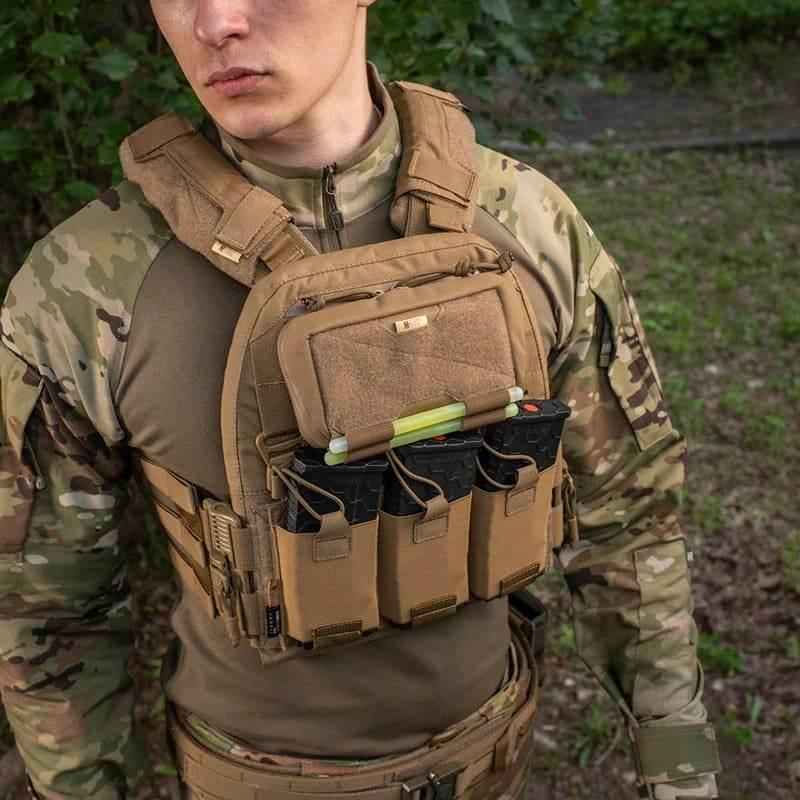 Bolsillo admin MOLLE coyote montado en chaleco táctico, abierto con contenido visible